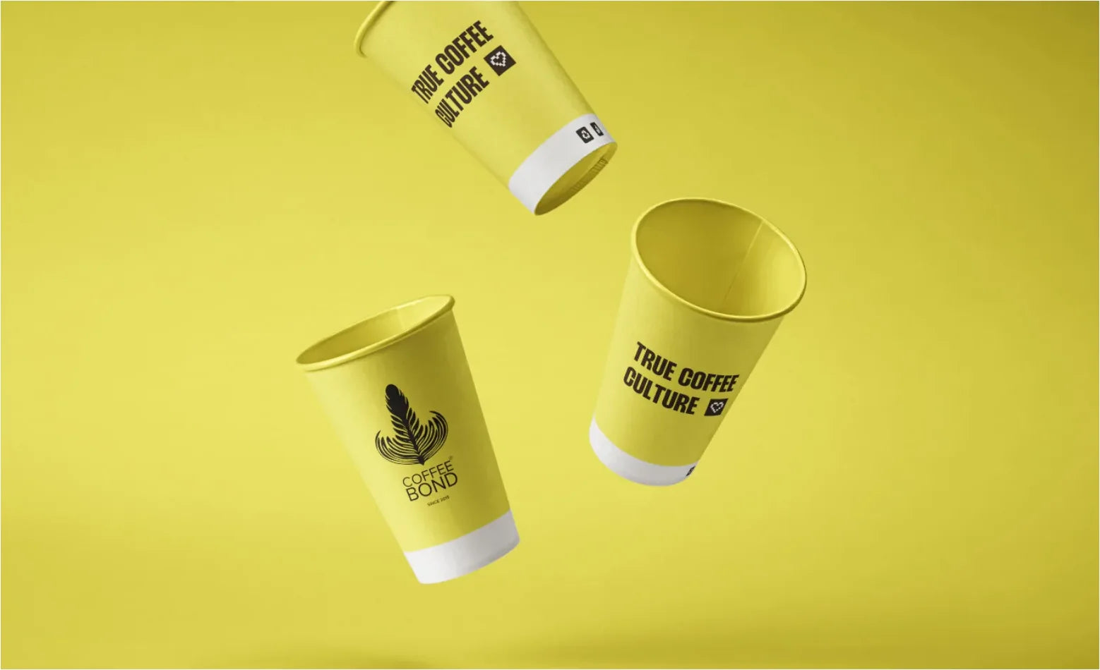 Three yellow Coffee Bond paper cups with the leaf logo