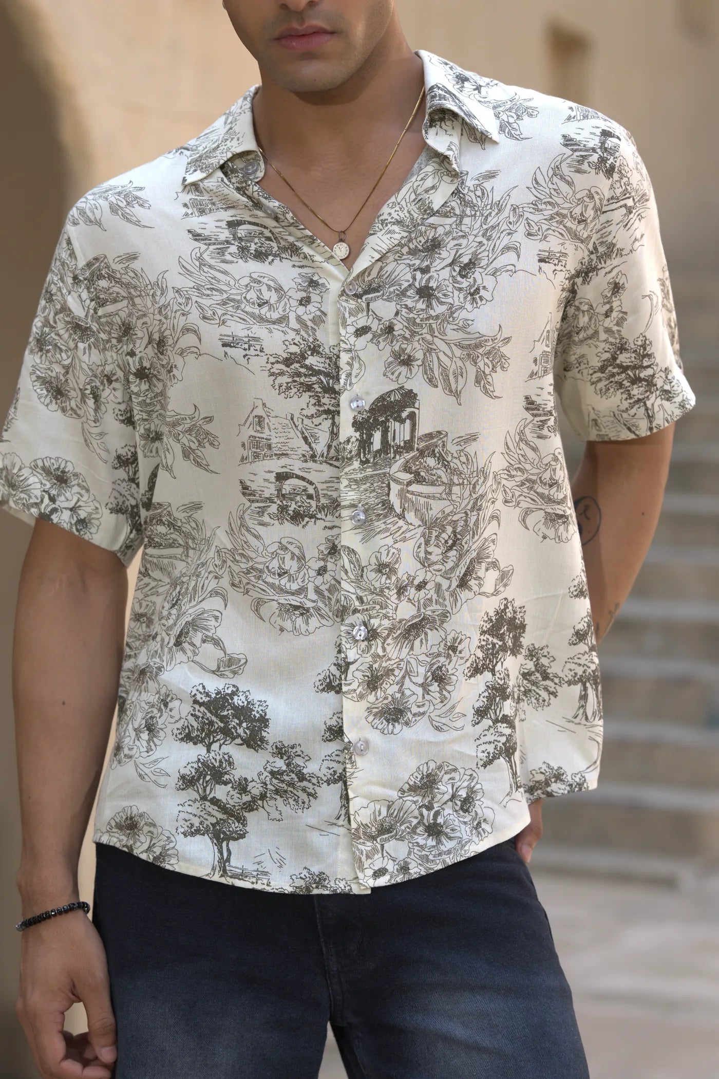 Close view of the grey toile print on the shirt, showing the pattern and collar