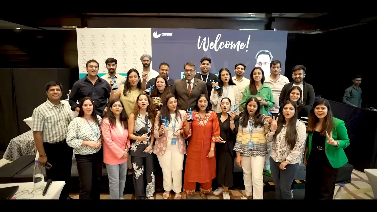 Frame from the BASE event film: a group of attendees standing together in front of a Welcome screen