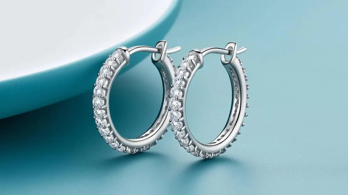 Diamond hoop earrings on a pale surface
