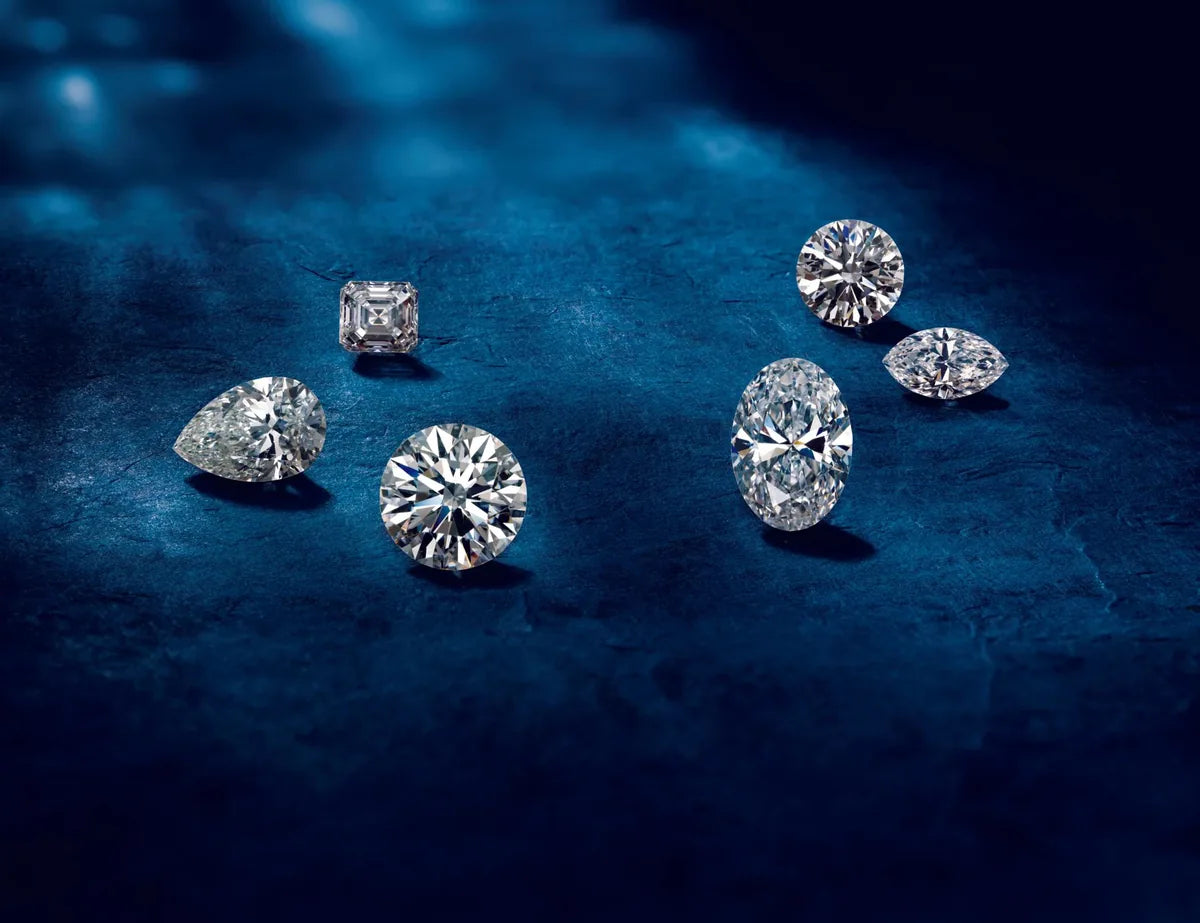 Loose diamonds of different shapes on blue fabric