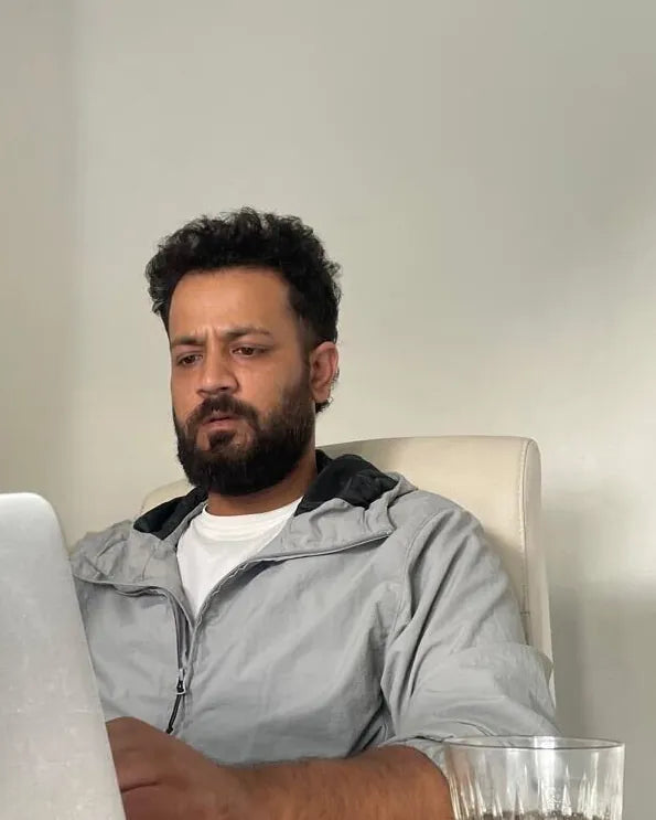 Rishabh Gambhir, Business Consultant, working at a laptop at a table